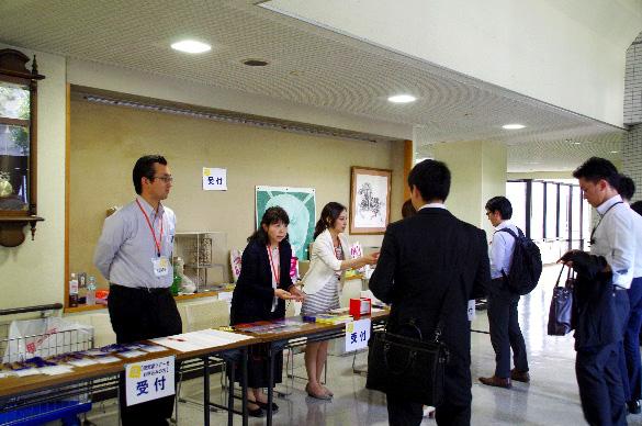 Reception desk with participants registering for the meeting.